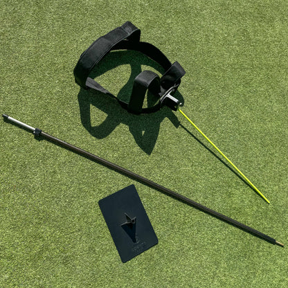 Pieces of the golf training aid harness on grass